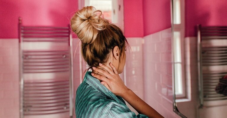 GRT-female-hair-looking-in-bathroom-mirror-hand-on-neck-1200x628-facebook.jpg