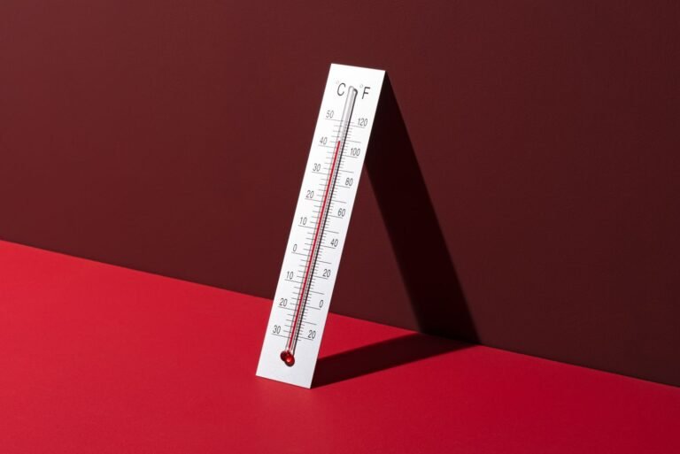 ac-temperature-setting-during-heat-wave-thermometer-on-red-background-GettyImages-1484622360-43ae4ae.jpeg